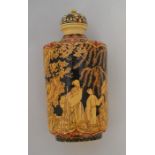 A 19th Century Japanese inlaid ivory snuff bottle decorated with figures on horseback and walking