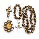 An 18th century reliquary rosary, each bead with four glazed panels containing what is possibly