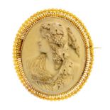 A large 19th century oval lava cameo brooch, carved depicting a bacchante with grapevine and bird,
