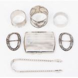 Three napkin rings, cigarette case, pair of shoe buckles, sugar tongs, 6.11 ozt approx (Q)