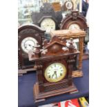 A collection of five late-19th Century mantle clocks, to include: various wooden cased examples, one