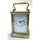 A brass carriage clock, bearing white enamel dial and Roman numerals, no makers marks, height