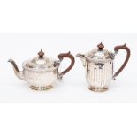 A George V silver part tea service including teapot, hot water jug, fluted bodies, by William