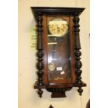 A late Victorian, German, mahogany wall clock, eight day, with pendulum and key, height 64cm