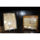 A 1930's Elliott mantle clock; together with a framed Staffordshire map, dated 1847, Johnson. (2)