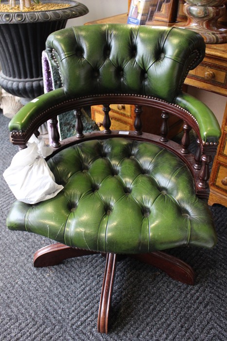 A green leather 20th Century desk chair, swivel movement
