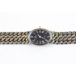An Omega De Ville wristwatch with oval midnight blue dial, heavy link silver curb link chain