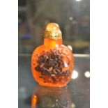 An early 20th Century Chinese  carved amber scent/snuff bottle, with  carp decoration and Chinese