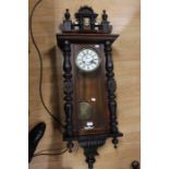 A late 19th Century to early 20th Century German eight day mahogany wall clock with key and