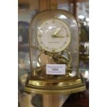 A mid-20th century mantle clock, raised on brass legs and complete with pendulum, Schatz, Germany