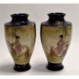 A pair of early 20th century Japanese vases depicting a group of men and women, black ground, height