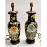 A pair of Japanese style 20th century lamp bases with floral decoration on a black ground, height