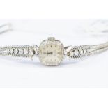 Rolex- A diamond set 18ct white gold ladies Rolex wrist watch, circa 1950's, cushion shaped