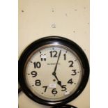 Scientific Clock MFG Co.; An early 20th Century, round, ebonised wall clock, Scientific, face