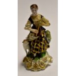 An 18th Century, Derby figurine, depicting a shepherdess playing a musical instrument, height