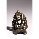 House ShrineBronzeIndia16th ctH: 8 cmA small house shrine with two deities before an aureole.S894