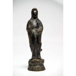 GuanyinBronzeChina19th ctH: 20 cmStanding Guanyin on lotus base holding a vase in the left hand to