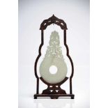 Chinese Jade Bi in wood frameWhite JadeChinaH: 30 cm This delicately carved jade bi comes in a