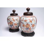 2 Chinese Imari VasesPorcelainChina 19th ctH: 35 cmSet of two Chinese Imari vases with wooden