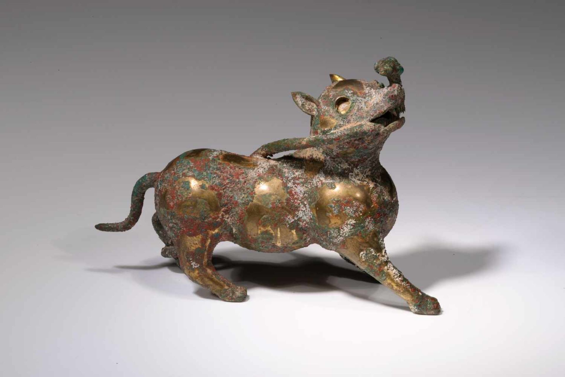 AUSPICIOUS ANIMAL IN FORM OF A DOGbronze,China, Han Dynasty,Size: 13,2 cm x 9 cmThe Han Emperor Ling