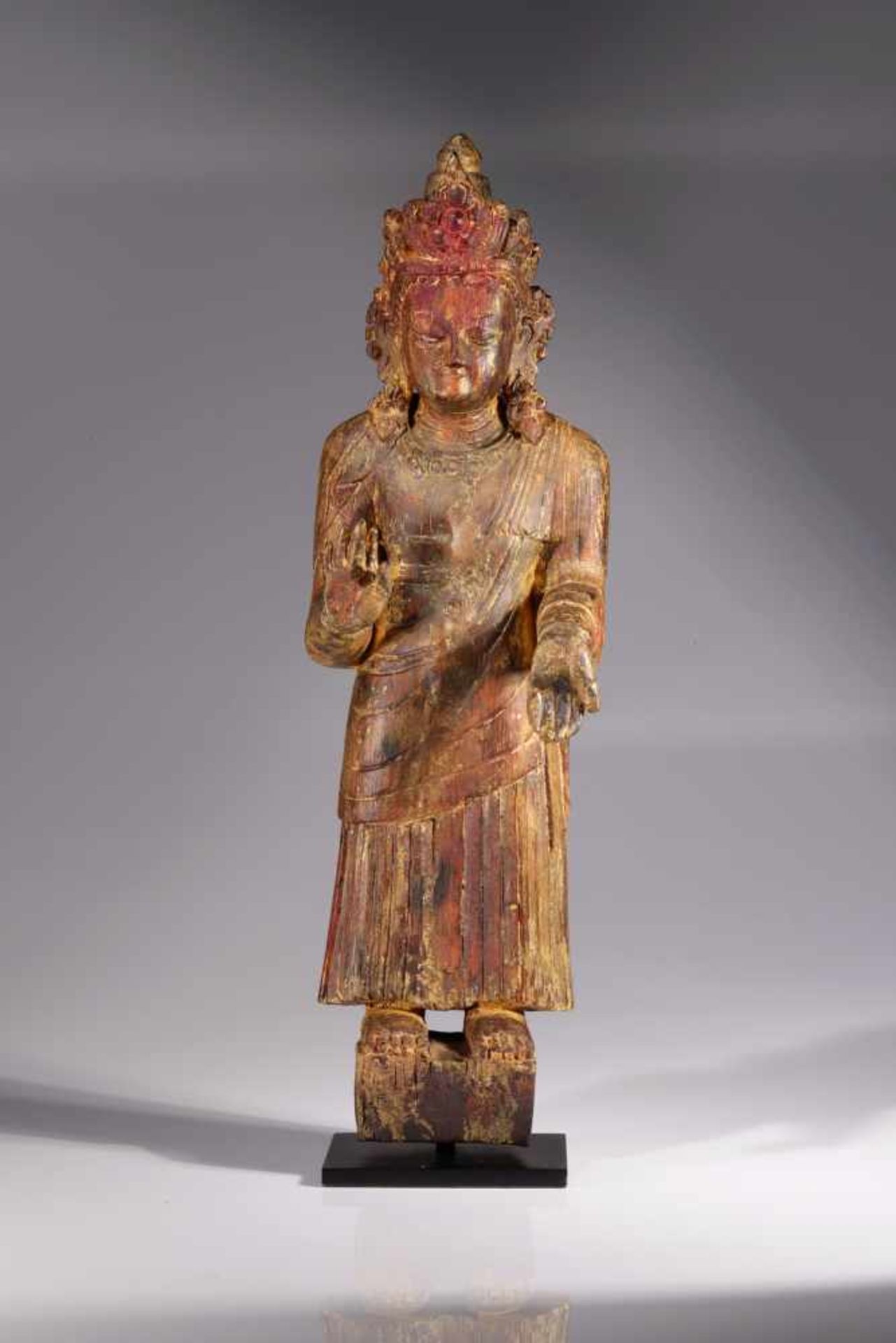 BUDDHA DIPANKARAwood,Nepal, 16 th century,Size: 51 cmStanding Buddha of the past with right hand