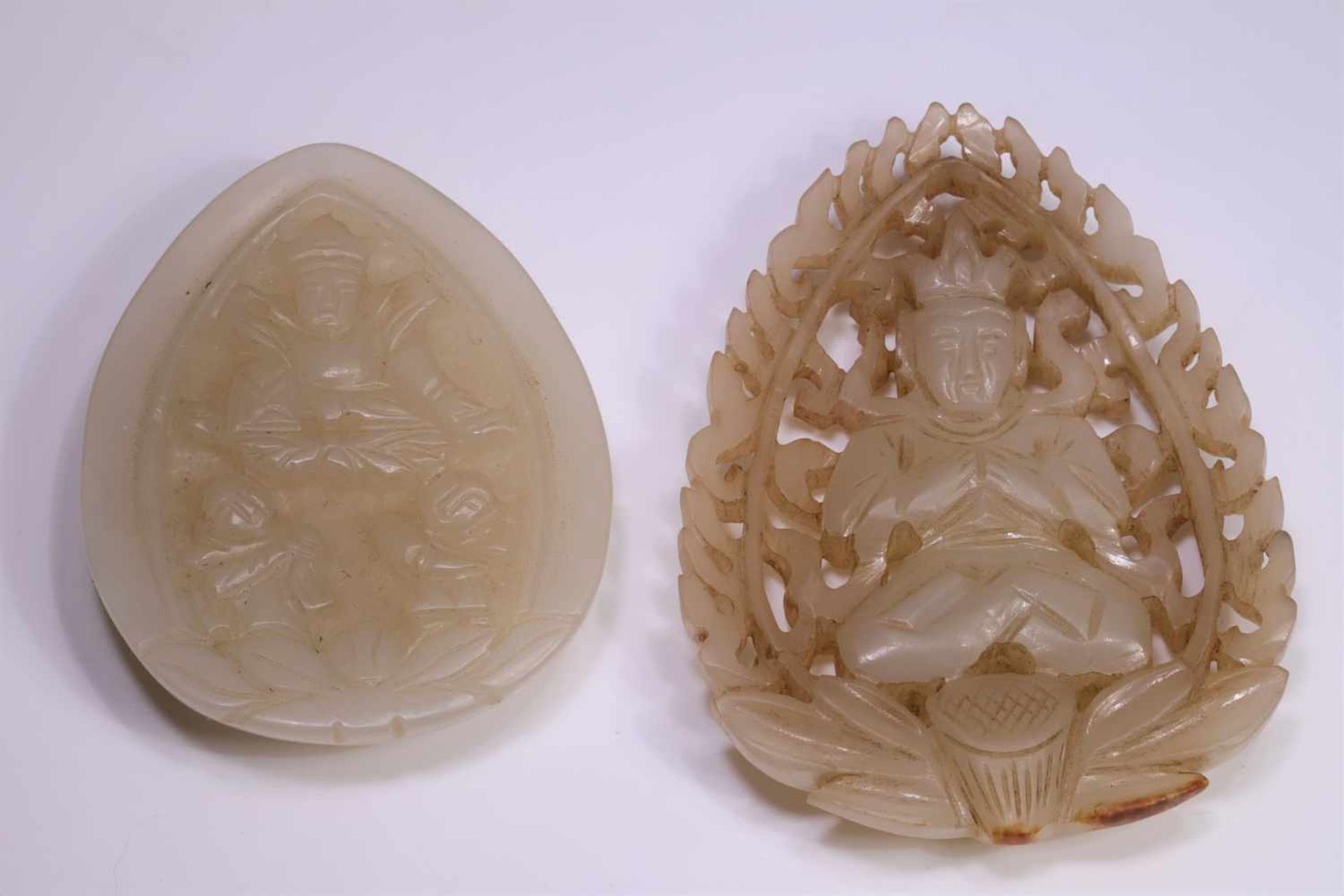 TWO WHITE JADE PENDANTSwhite Jade with Buddha decorationChina, 19th century, Qing DynastySize: 5