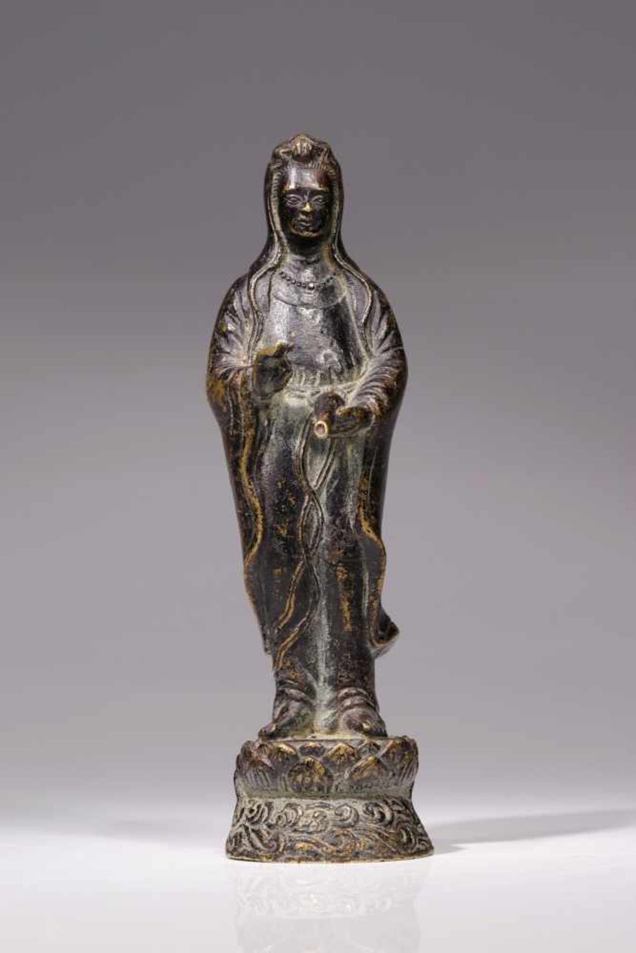 GUANYINbronze,China, 19th century,Size: 20 cmStanding Guanyin on lotus base holding a vase in the