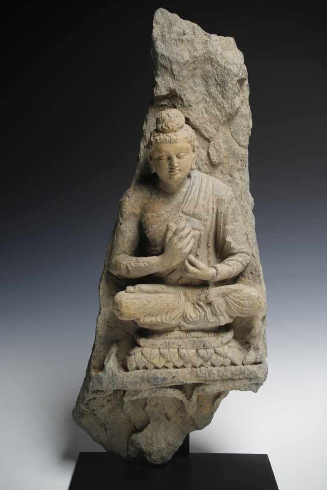 GANDHARA BUDDHAgrey schist with restgilding,Gandhara, 3rd century,Size: 68 cm x 30 cmBuddha