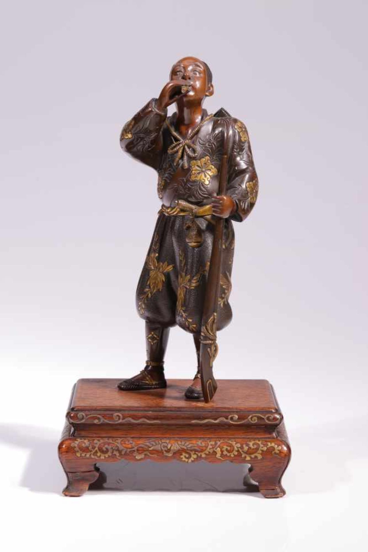 EXTREMLY FINE BRONZE IN FORM OF A DUCK HUNTER WITH FLUTEBronze with gold inlays, signed by "Miyao