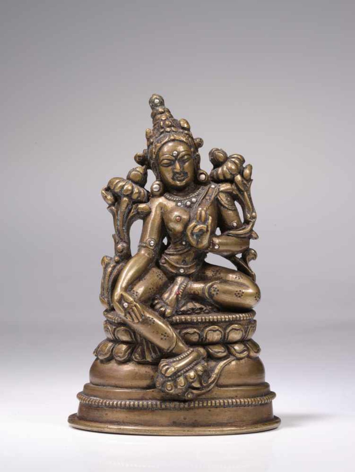 MAGNIFICENT GREEN TARA Bronze with silver and copper inlays, Inscription on the back Tibet, 12th