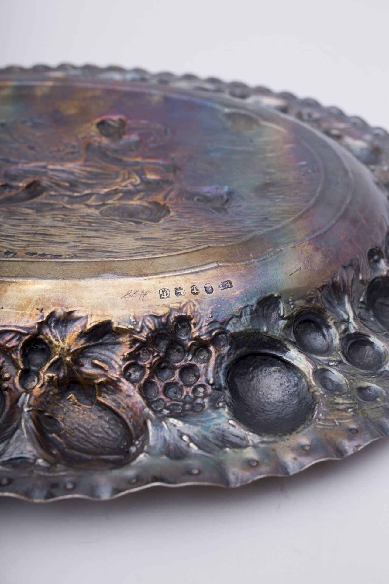 Display plate: Silver, oval-shaped with an embossed scene depicting a goddess riding two dolphins. - Image 2 of 2