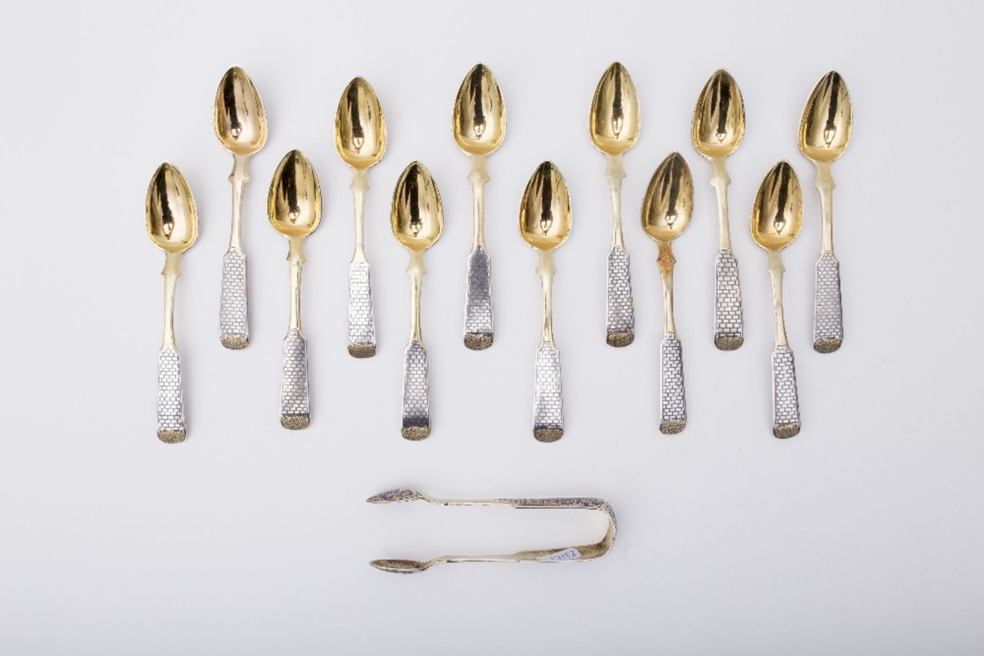 Russia Set of 12 spoons and sugar tongs: Vermeil and niello. The small spoons are adorned with a