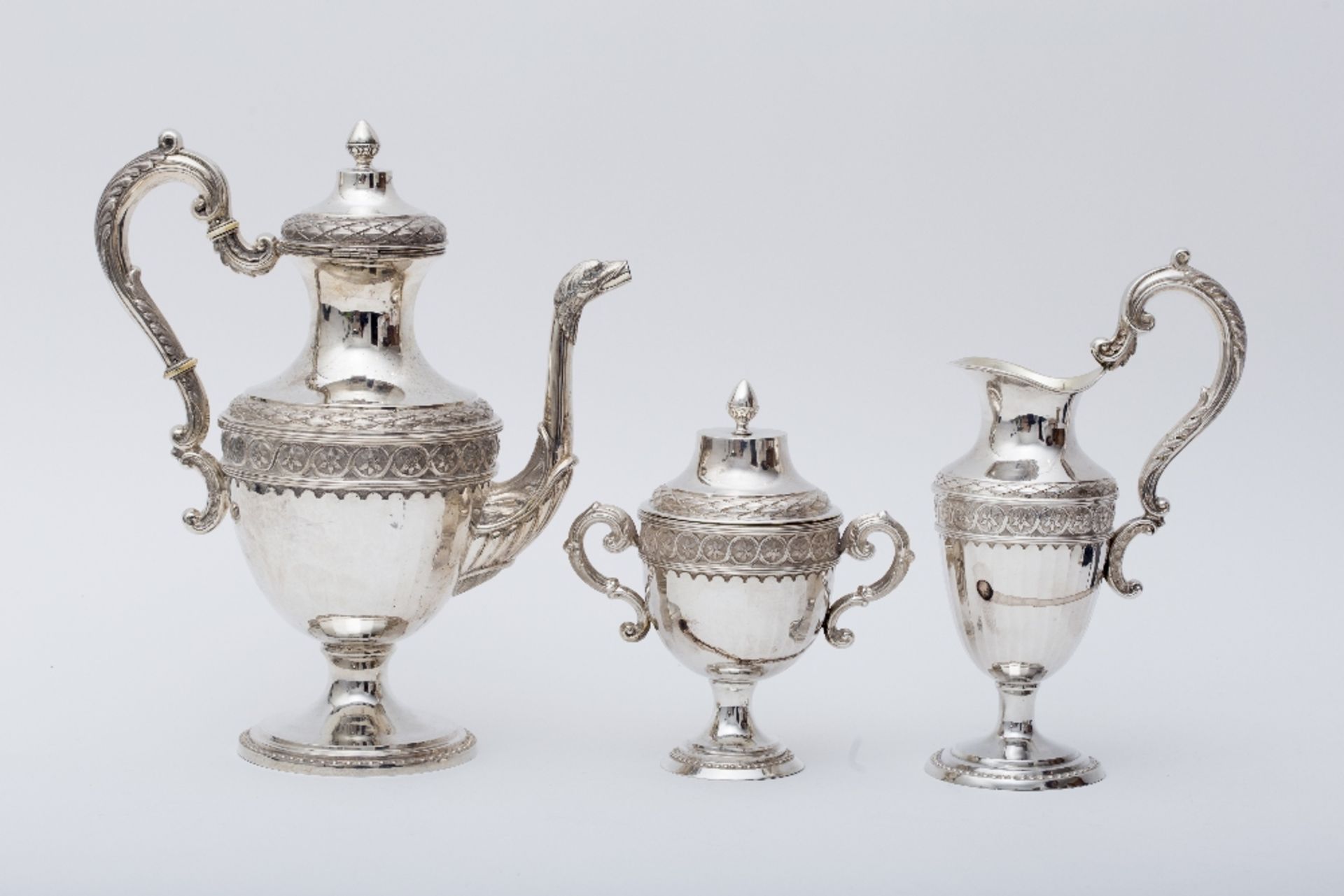 Coffee set: Silver with a footed base, decorated with beaded frieze. Composed of a coffee pot, a