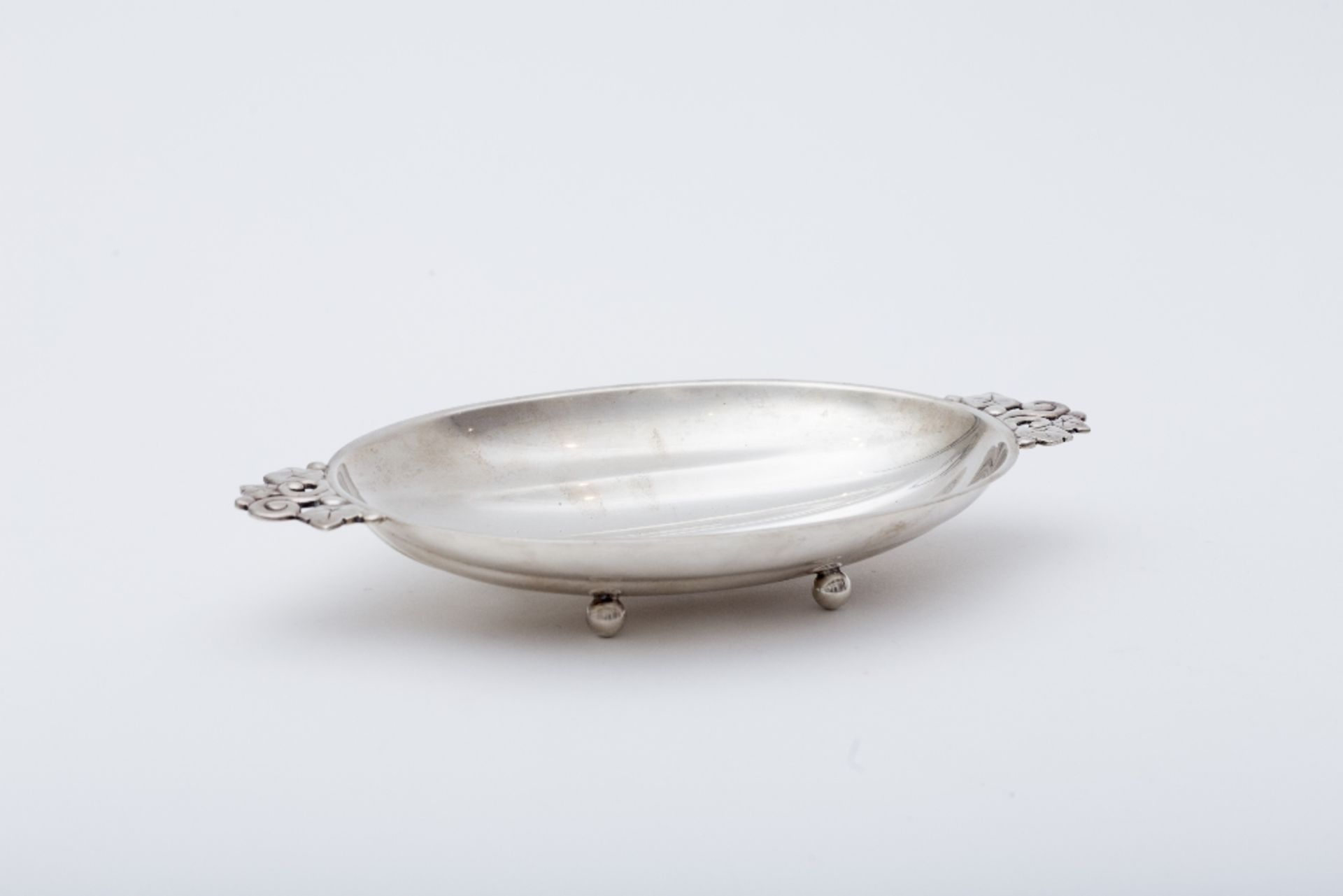 Tiffany & Co Coin tray: Sterling silver depicting a sort of half-gourd with vine-leaf handles.