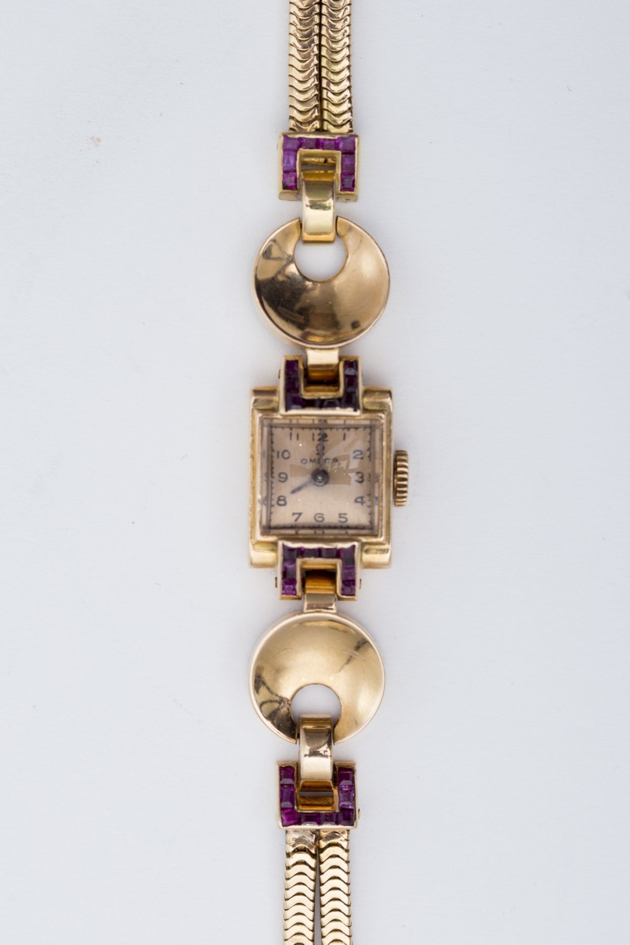 Omega Lady's 1950's watch: 18 kt rose gold, adorned with two asymmetrical disks, set with small