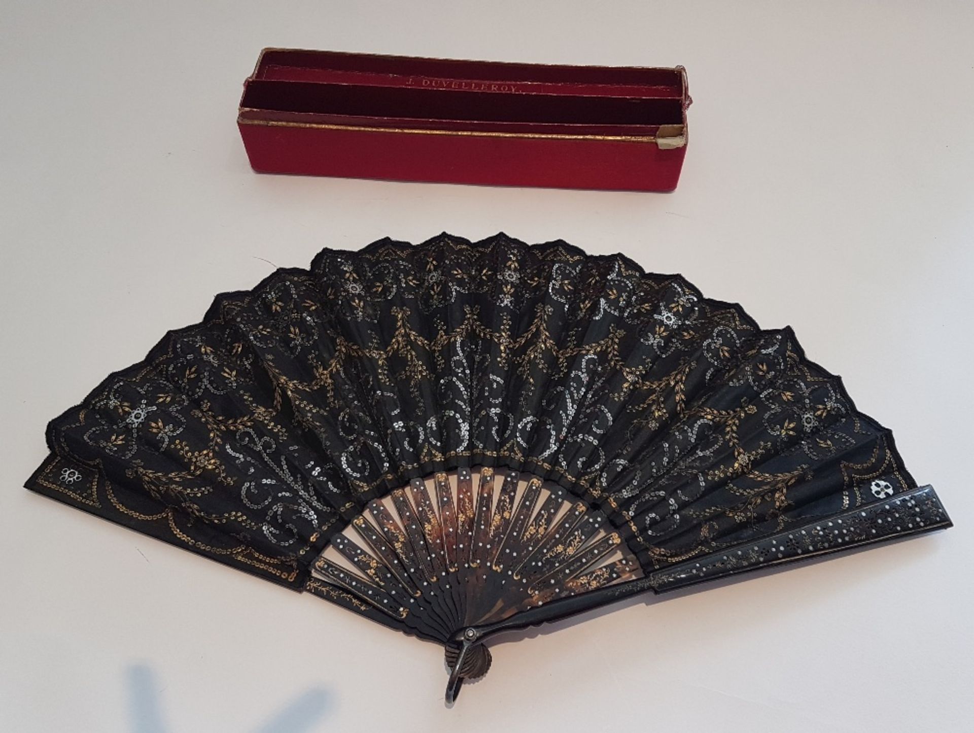 Fan; Carved gilded tortoiseshell and embroidered sequins. In a box marked " J.DUVELLROY, 167