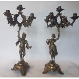 Pair of candelabra; Bronze with gold patina, depicting lavishly attired figures. H: 58 cm