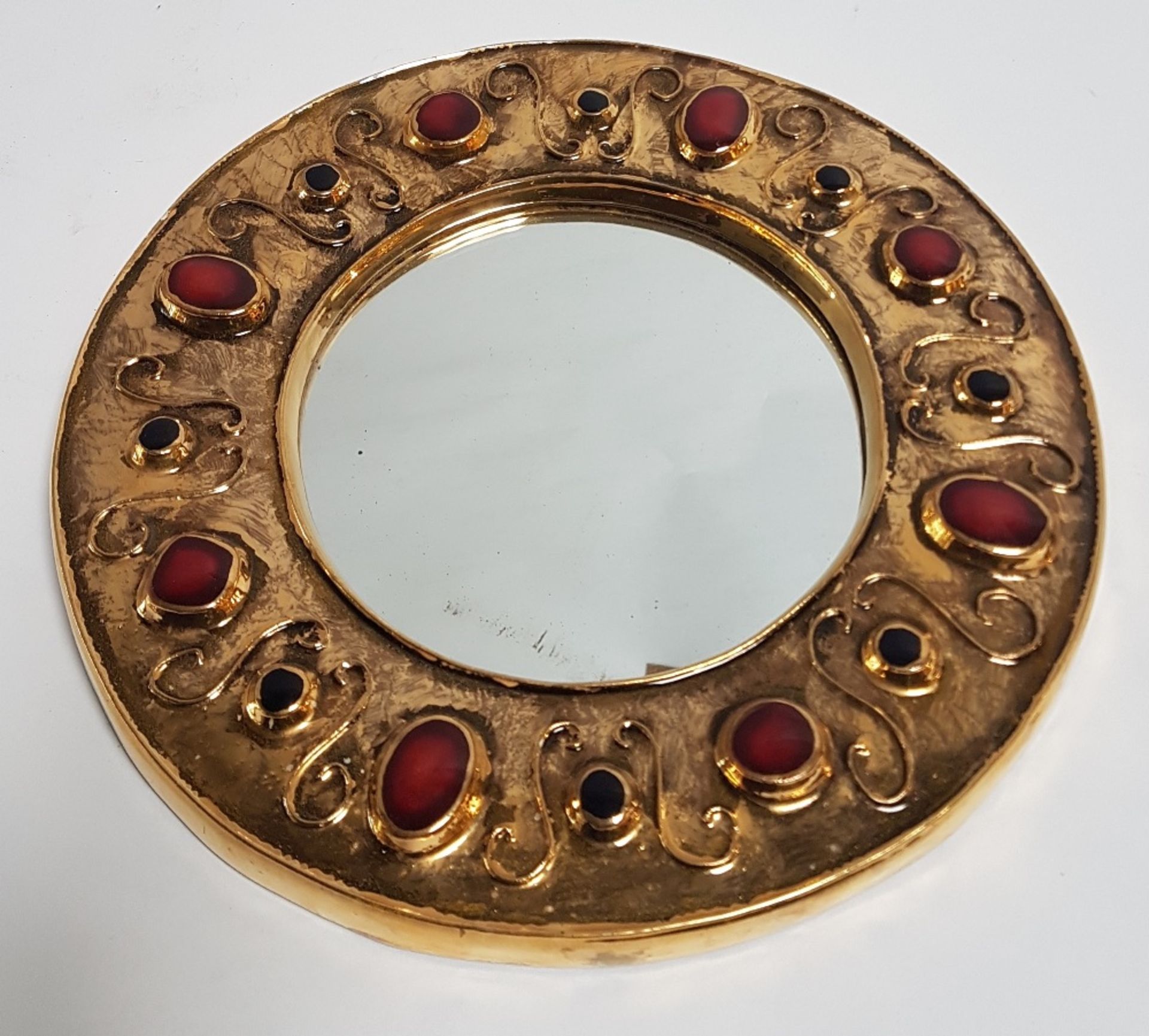 François Lembo (1930-2013) Round mirror; Ceramic with golden, red and black enamelled glaze.