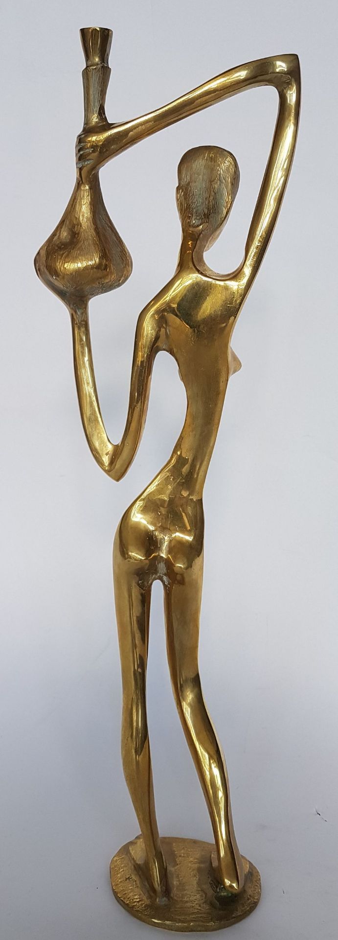 Alfred Liyolo (Born in 1943), Attributed toWoman with a jar; Gilded bronze sculpture. 43.5 x 13 x