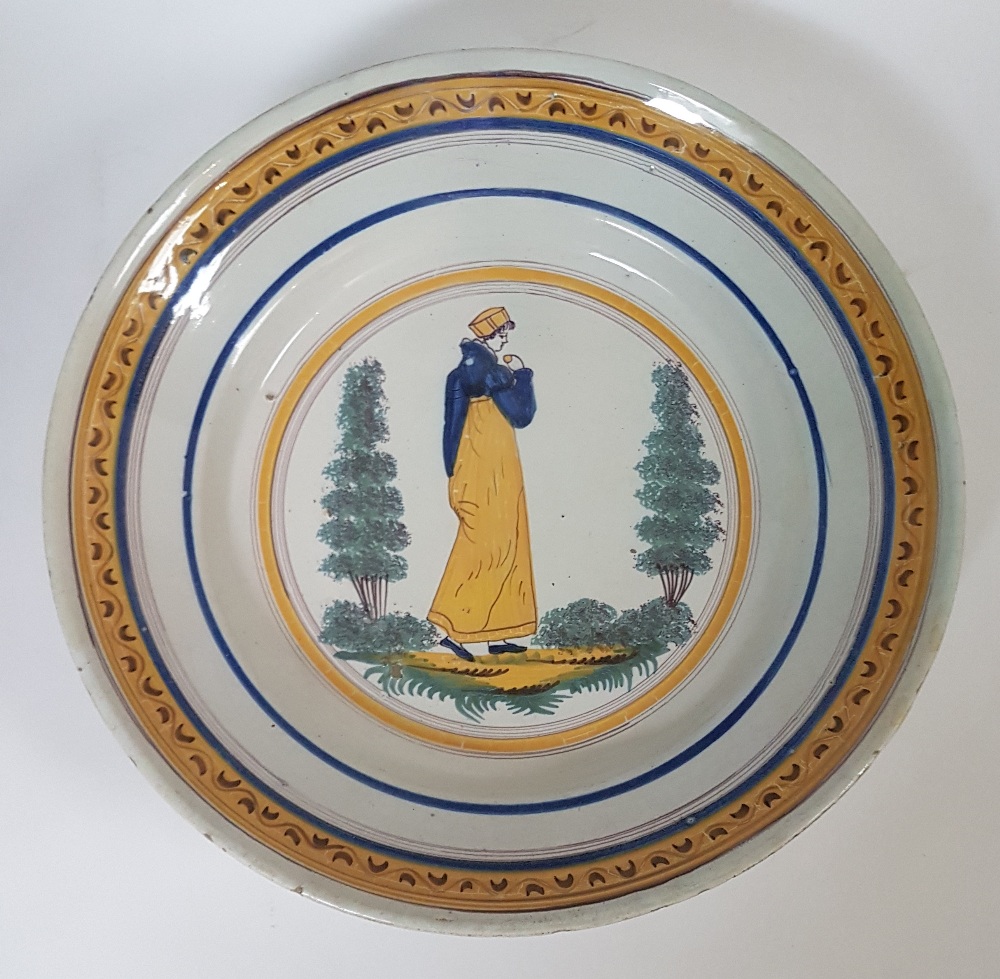 BrusselsWoman in a garden; Earthenware plate with polychrome décor on a white ground. Chipped D: