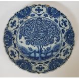 Delft, 18th centuryFlowering tree; Earthenware dish with blue décor on a white ground. Signed on the