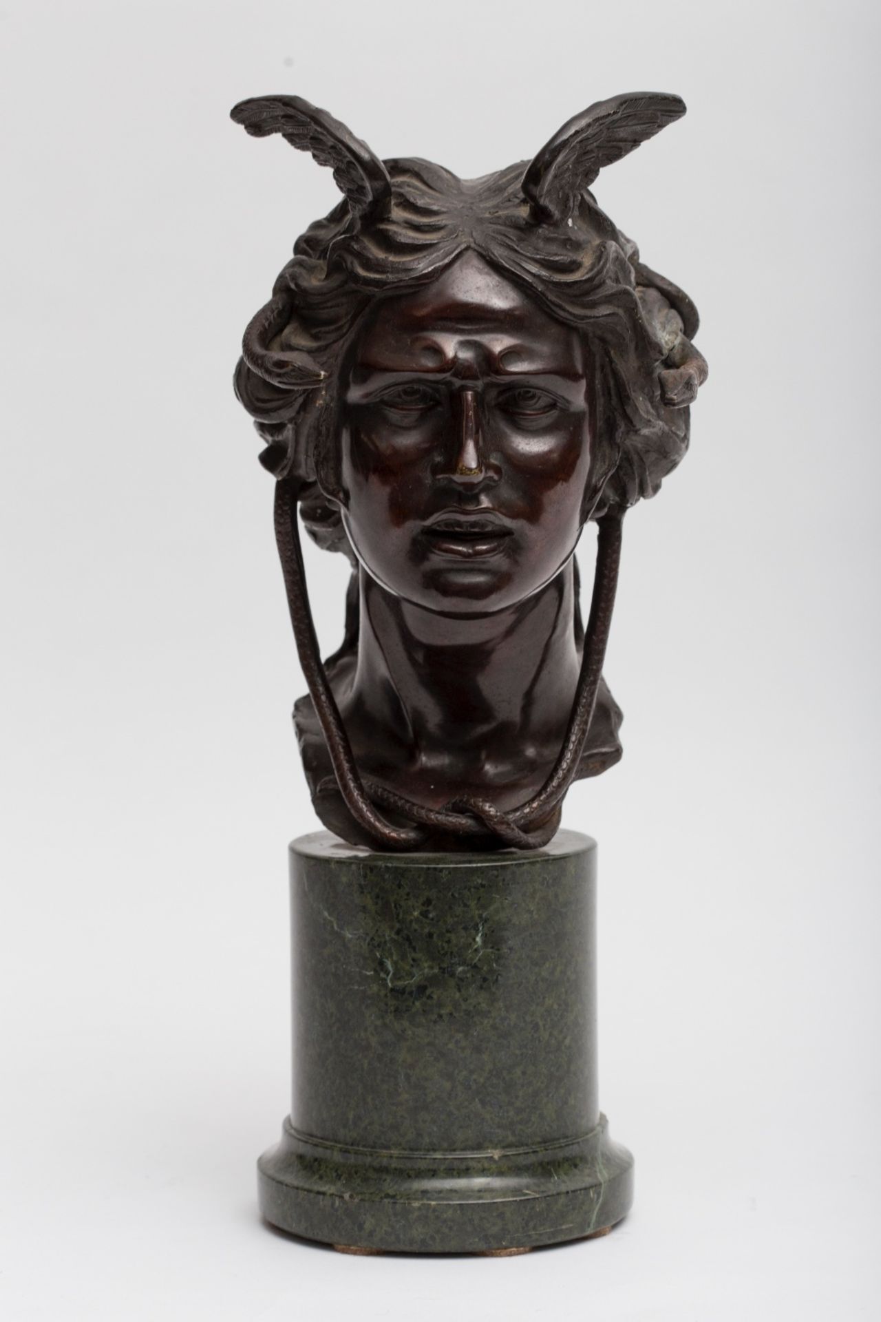 19th century workGorgon; Bronze sculpture with dark brown patina. Sea green marble stand. 43 x 20