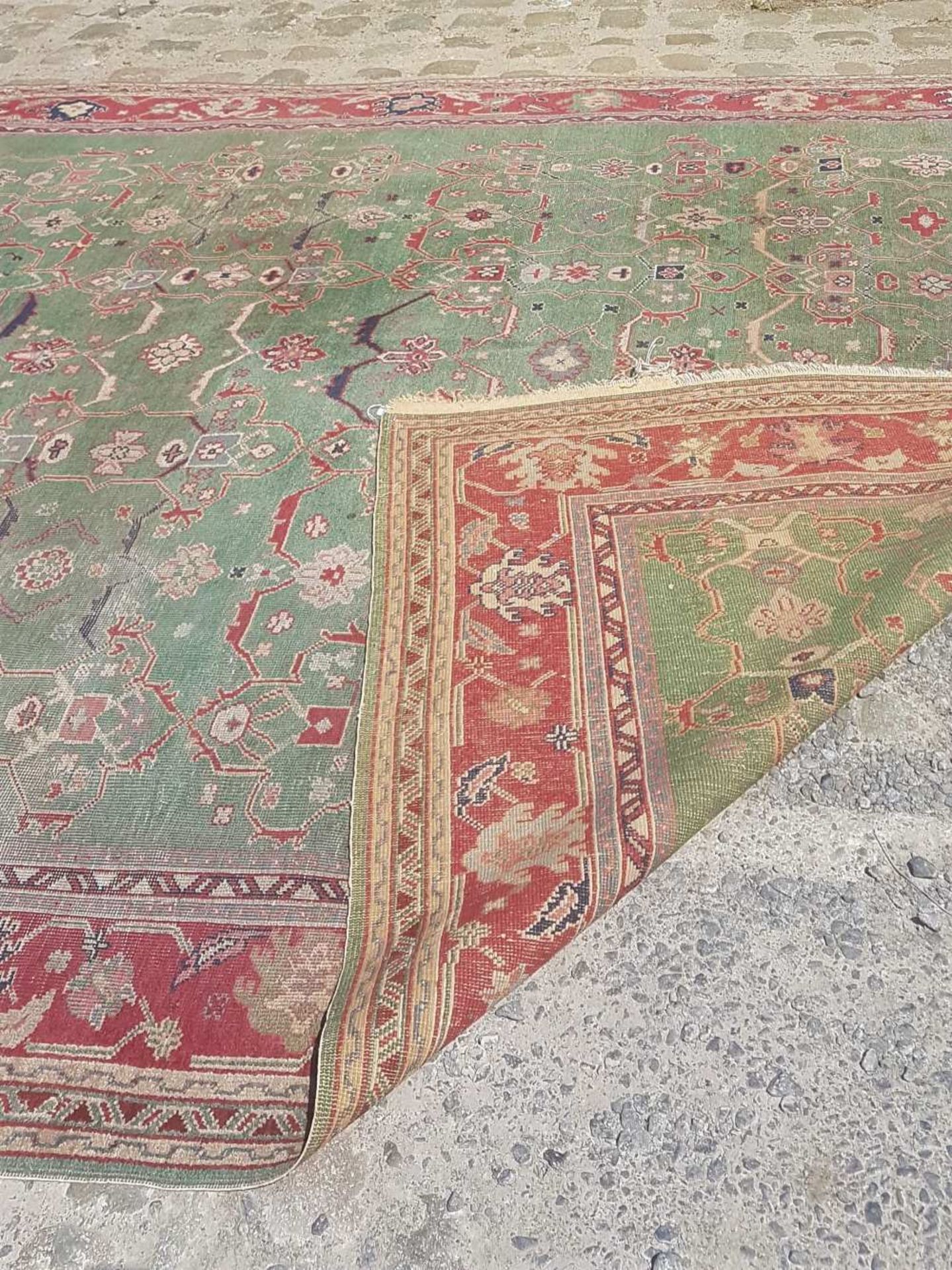 Middle EastRug; Wool, with green ground and red décor. Used condition. 348 x 260 cm - Image 2 of 2