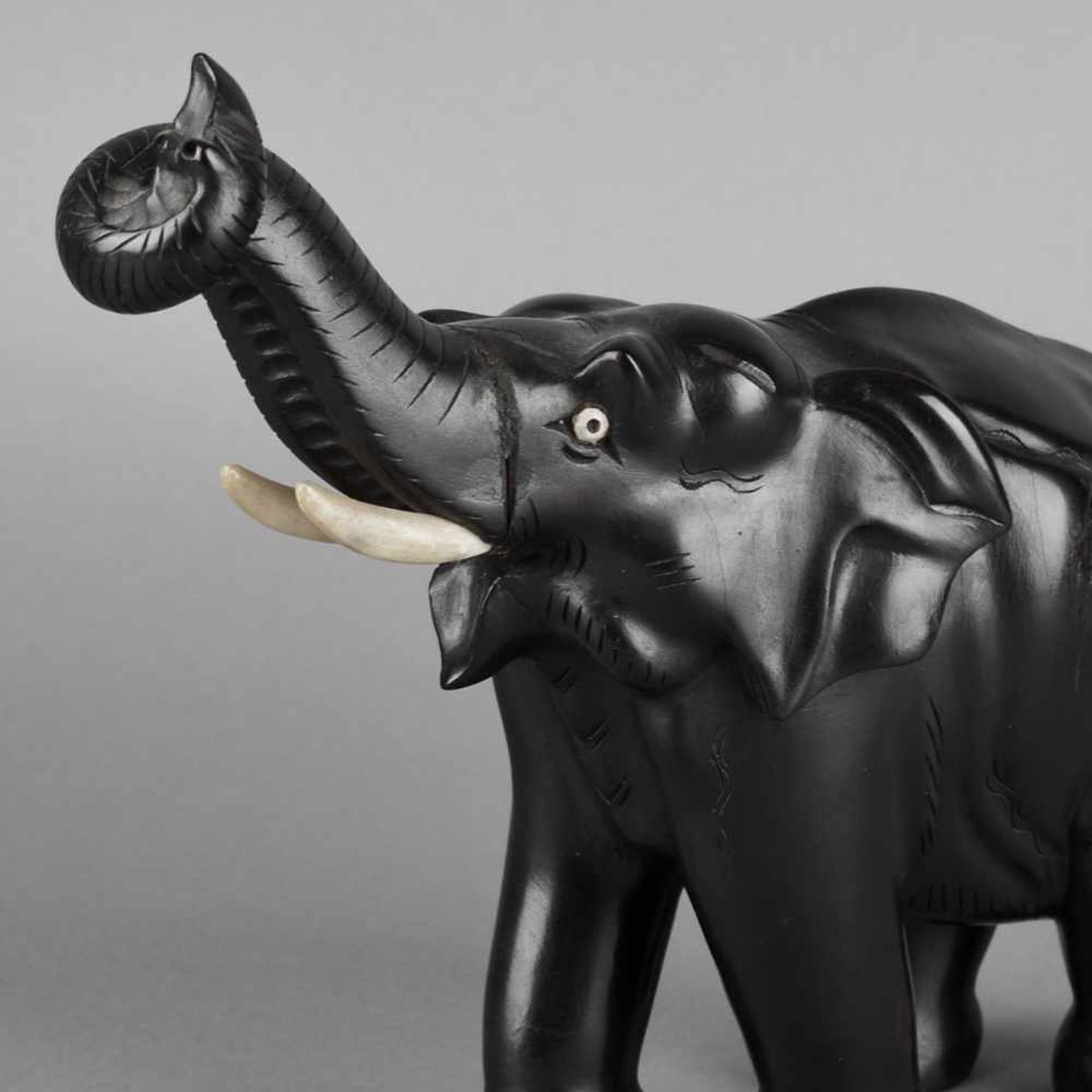 Elefantenfigur Tropenholz, geschnitzt und schwarz bemalt, schreitender Elefant mit erhobenem Rüssel,