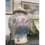 20th cent. Oriental ginger jar and cover decorated with fruit and flowers. Approx 15ins.