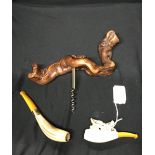 Smoking Requisites: Two Meerschaum pipes. One with amber coloured stem, bone bowl carved with dogs