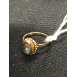 Hallmarked Gold Jewellery: Black opal, oval cut mounted in a decorative wire work design, 9ct gold