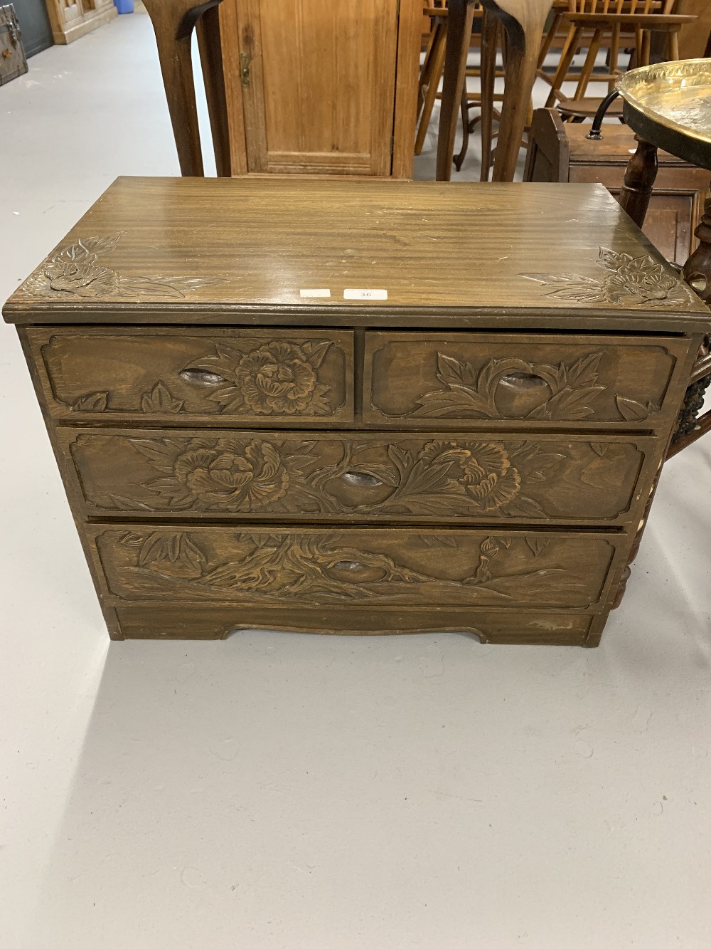 20th cent. Japanese cedar wood 2/2 low chest of drawers, carved with chrysanthemums. 24ins. x 18ins.