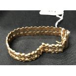 Gold Jewellery: Double link articulated bracelet mark and test 750 with safety chain. Length 8½ins.