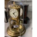 20th cent. Anniversary clock, under glass dome, enamel dial, Arabic numerals. Makers mark Bidische